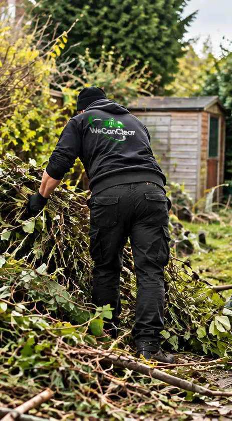 A We Can Clear worker cutting back an overgrown garden